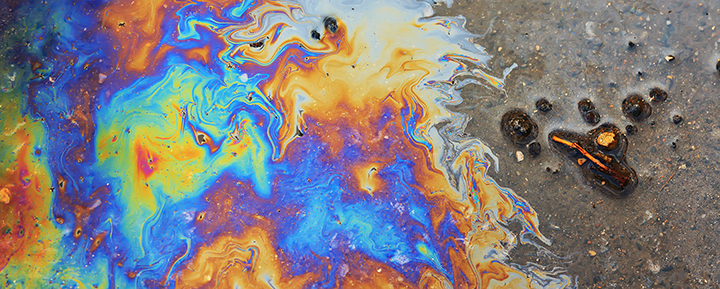 Rainbow-colored oil sheen floating on water